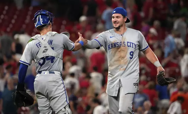 Kansas City Royals' Vinnie Pasquantino (9) and Freddy Fermin celebrate an 8-5 victory over the St. Louis Cardinals in the second game of a baseball doubleheader Wednesday, July 10, 2024, in St. Louis. (AP Photo/Jeff Roberson)