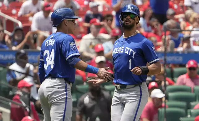 Kansas City Royals' MJ Melendez (1) and Freddy Fermin (34) celebrate after scoring on a double by teammate Garrett Hampson during the fifth inning in the first game of a baseball doubleheader against the St. Louis Cardinals Wednesday, July 10, 2024, in St. Louis. (AP Photo/Jeff Roberson)