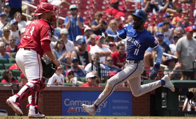 Kansas City Royals' Maikel Garcia (11) scores past St. Louis Cardinals catcher Pedro Pages during the eighth inning in the first game of a baseball doubleheader Wednesday, July 10, 2024, in St. Louis. (AP Photo/Jeff Roberson)