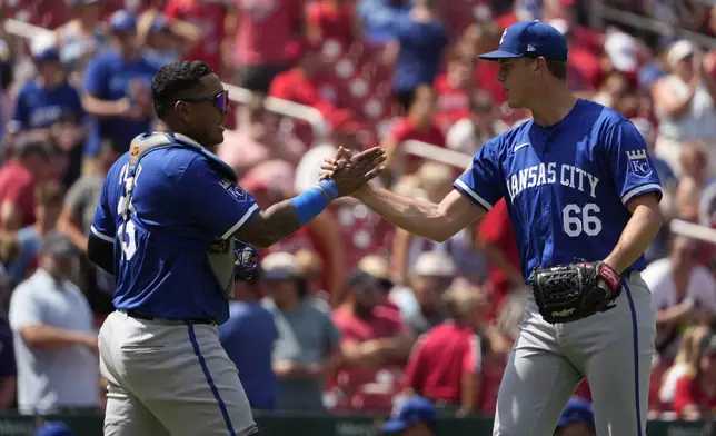 Kansas City Royals relief pitcher James McArthur (66) and catcher Salvador Perez celebrate a 6-4 victory over the St. Louis Cardinals in the first game of a baseball doubleheader Wednesday, July 10, 2024, in St. Louis. (AP Photo/Jeff Roberson)