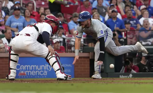 Kansas City Royals' Kyle Isbel, right, scores past St. Louis Cardinals catcher Willson Contreras during the fifth inning in the second game of a baseball doubleheader Wednesday, July 10, 2024, in St. Louis. (AP Photo/Jeff Roberson)