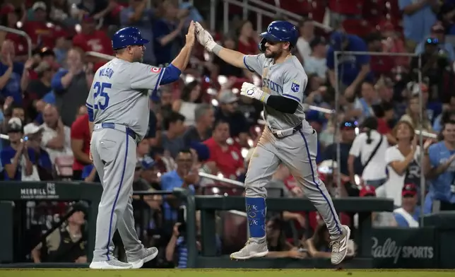 Kansas City Royals' Kyle Isbel, right, is congratulated by third base coach Vance Wilson after hitting a solo home run during the ninth inning in the second game of a baseball doubleheader against the St. Louis Cardinals Wednesday, July 10, 2024, in St. Louis. (AP Photo/Jeff Roberson)