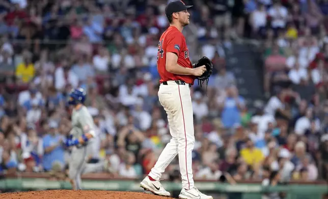 Boston Red Sox starting pitcher Cooper Criswell stands on the mound after giving up a solo home run to Kansas City Royals' Bobby Witt Jr., back left, during the fourth inning of a baseball game, Friday, July 12, 2024, in Boston. (AP Photo/Michael Dwyer)