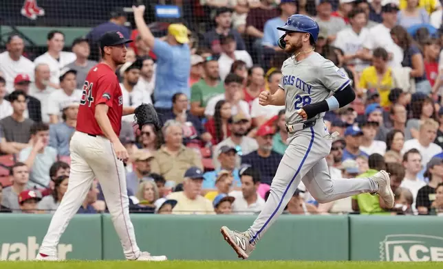 Kansas City Royals' Kyle Isbel (28) scores on a sacrifice fly by Vinnie Pasquantino off starting pitcher Cooper Criswell (64) during the second inning of a baseball game, Friday, July 12, 2024, in Boston. (AP Photo/Michael Dwyer)