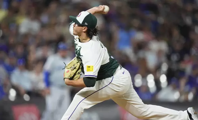 Colorado Rockies relief pitcher Victor Vodnik works against the Kansas City Royals in the ninth inning of a baseball game Saturday, July 6, 2024, in Denver. (AP Photo/David Zalubowski)