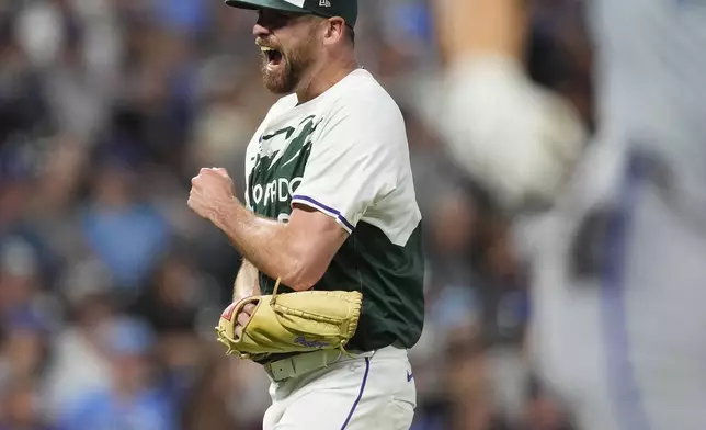 Colorado Rockies starting pitcher Austin Gomber, back, reacts after getting Kansas City Royals' Kyle Isbel to fly out to end the top of the seventh inning of a baseball game Saturday, July 6, 2024, in Denver. (AP Photo/David Zalubowski)