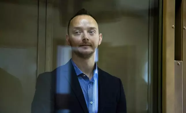 FILE - Ivan Safronov, an adviser to the director of Russia's state space agency, stands in a defendant’s cage in a courtroom in Moscow, Russia, on Thursday, July 16, 2020. Safronov, a former military affairs journalist, was convicted of treason and sentenced to 22 years in prison. Authorities accused him of passing military secrets to Czech intelligence and a German national, which he denied. The case has been widely viewed as retaliation for his reporting. (AP Photo/Alexander Zemlianichenko, File)