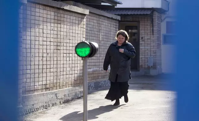 FILE - Oksana Sevastidi leaves Lefortovo Prison in Moscow, Russia, on Sunday, March 12, 2017. Sevastidi, a bakery worker in the Black Sea resort of Sochi, was convicted of treason and sentenced to seven years in prison after she sent a text message to a friend in neighboring Georgia about seeing military equipment carried on a nearby railway prior to Russia’s brief war in 2008 with its neighbor. President Vladimir Putin pardoned her in 2017. (AP Photo/Denis Tyrin, File)