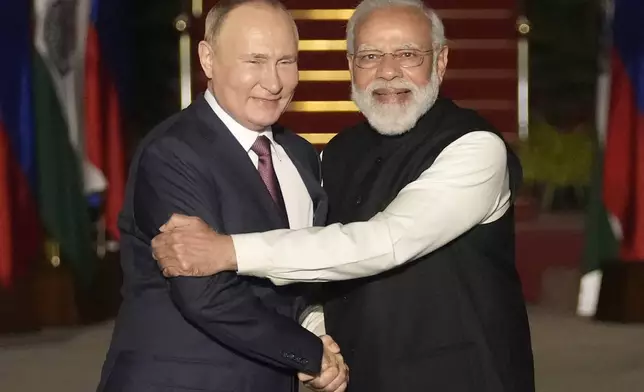 FILE - Russian President Vladimir Putin, left, and Indian Prime Minister Narendra Modi greet each other before their meeting in New Delhi, India on Dec. 6, 2021. Modi on Monday begins a two-day visit to Russia that is his first since Moscow sent troops into Ukraine, a conflict that has complicated the relationship between the longtime allies by pushing Russia closer to India's rival China. (AP Photo/Manish Swarup, File)