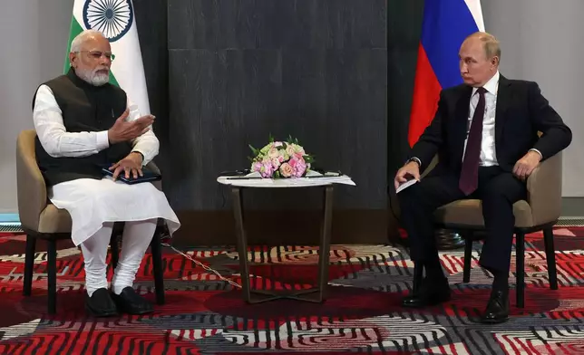 FILE - Russian President Vladimir Putin, right, listens to Indian Prime Minister Narendra Modi during their talks on the sidelines of the Shanghai Cooperation Organisation (SCO) summit in Samarkand, Uzbekistan, on Sept. 16, 2022. Modi on Monday begins a two-day visit to Russia that is his first since Moscow sent troops into Ukraine, a conflict that has complicated the relationship between the longtime allies by pushing Russia closer to India's rival China. (Sergei Bobylev, Sputnik, Kremlin Pool Photo via AP)