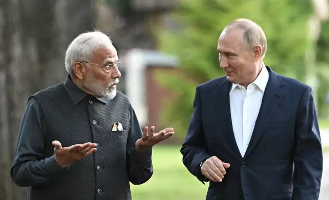 Indian Prime Minister Narendra Modi, left, and Russian President Vladimir Putin walk during an informal meeting at Novo-Ogaryovo residence, outside Moscow, Russia, Monday, July 8, 2024. (Sergei Bobylev, Sputnik, Kremlin Pool Photo via AP)