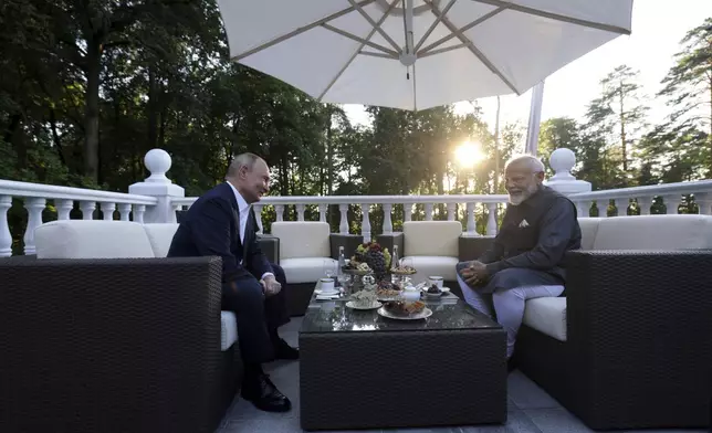 Russian President Vladimir Putin, left, speaks with Indian Prime Minister Narendra Modi during an informal meeting at Novo-Ogaryovo residence, outside Moscow, Russia, Monday, July 8, 2024. (Gavriil Grigorov, Sputnik, Kremlin Pool Photo via AP)