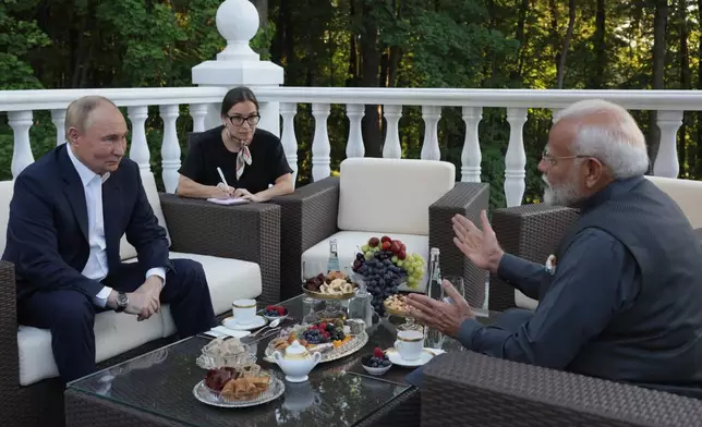 Russian President Vladimir Putin, left, speaks with Indian Prime Minister Narendra Modi during an informal meeting at Novo-Ogaryovo residence, outside Moscow, Russia, Monday, July 8, 2024. (Gavriil Grigorov, Sputnik, Kremlin Pool Photo via AP)