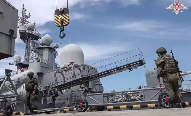 FILE - In this photo taken from video released by the Russian Defense Ministry on June 12, 2024, Russian military personnel load a cruise missile on board a warship during military drills with tactical nuclear weapons. (Russian Defense Ministry Press Service via AP, File)