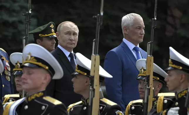 FILE - Russian President Vladimir Putin and Defense Minister Andrei Belousov, background right, attend a ceremony at the Tomb of the Unknown Soldier, in Moscow, on June 22, 2024. (Sergei Guneyev, Sputnik, Kremlin Pool Photo via AP, File)