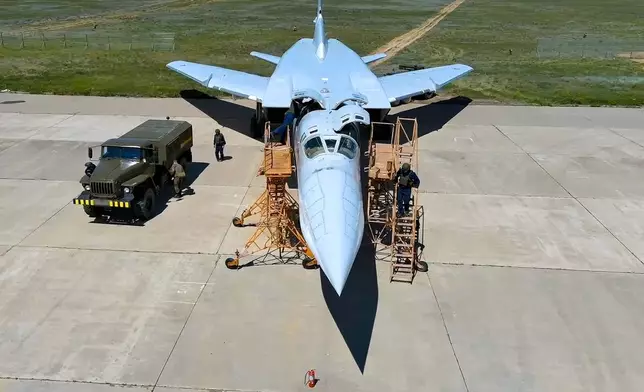 FILE - In this photo released by the Russian Defense Ministry on May 21, 2024, Russian air force crew work at an undisclosed location in Russia on a Tu-22M3 bomber for a training mission as part of military drills with tactical nuclear weapons. (Russian Defense Ministry Press Service via AP, File)