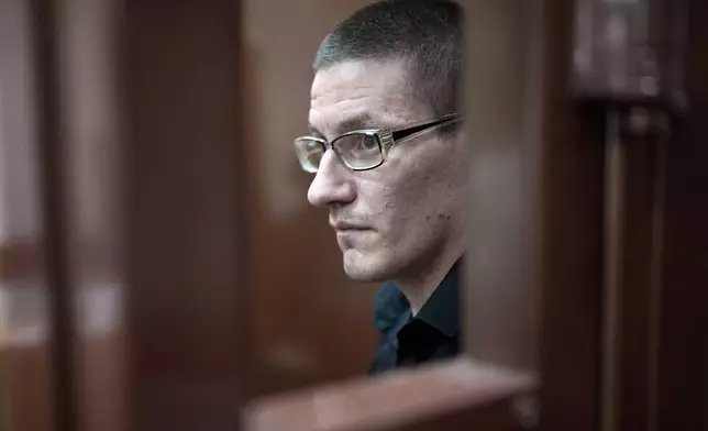 Robert Woodland, a Russia-born U.S. citizen, stands in a glass cage during a court hearing, Thursday, July 4, 2024, in Moscow, Russia. Woodland was convicted of drug-related charges and sentenced to 12 and a 1/2 years in prison on Thursday. (AP Photo/Alexander Zemlianichenko)