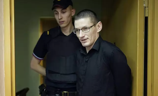 U.S. citizen Robert Woodland is escorted to a court room prior to a court session on drug-related charges in Moscow, Russia, Thursday, July 4, 2024. Woodland was arrested on drug charges in January and faces up to 20 years in prison if convicted. Robert Woodland, a Russia-born U.S. citizen, was convicted of drug-related charges by a Moscow court and sentenced to 12 1/2 years in prison on Thursday. (AP Photo/Alexander Zemlianichenko)
