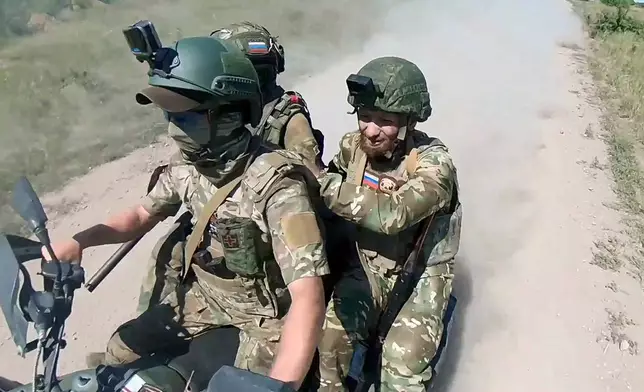 In this photo, taken from video released by the Russian Defense Ministry Press Service on Monday, July 1, 2024, Russian soldiers ride a quad bike changing their positions at the frontline in an undisclosed location in Ukraine. (Russian Defense Ministry Press Service via AP, File)