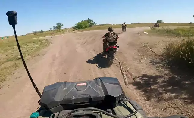 In this photo, taken from video released by the Russian Defense Ministry Press Service on Monday, July 1, 2024, Russian soldiers ride a quad bike and bikes changing their positions at the frontline in an undisclosed location in Ukraine. (Russian Defense Ministry Press Service via AP, File)