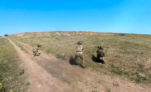 In this photo, taken from video released by the Russian Defense Ministry Press Service on Monday, July 1, 2024, Russian soldiers shoot toward an Ukrainian positions in an undisclosed location in Ukraine. (Russian Defense Ministry Press Service via AP, File)