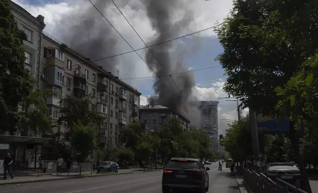 Smoke rises up after Russia's massive missile attack in central Kyiv, Ukraine, Monday, July 8, 2024. A major Russian missile attack across Ukraine killed at least 20 people and injured more than 50 on Monday, officials said, with one missile striking a large children’s hospital in the capital, Kyiv, where emergency crews searched rubble for casualties. (AP Photo/Efrem Lukatsky)