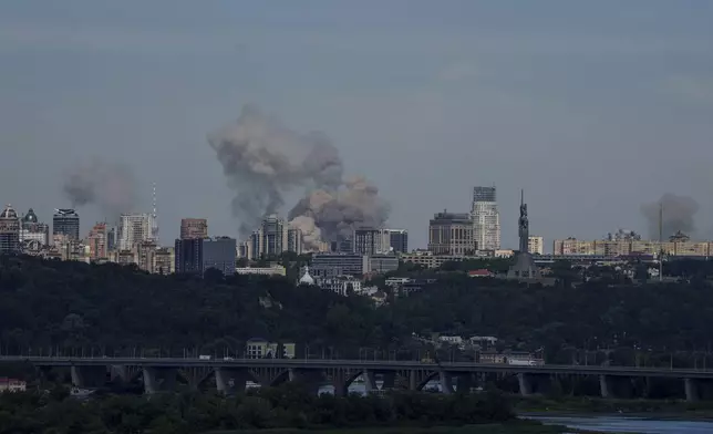 Smoke rises over the Kyiv skyline after a Russian attack, Monday, July 8, 2024. Russian forces launched multiple ballistic and cruise missiles against Ukrainian targets on Monday, Ukraine’s air force said, with explosions felt and heard across the capital, Kyiv. (AP Photo/ Evgeniy Maloletka)