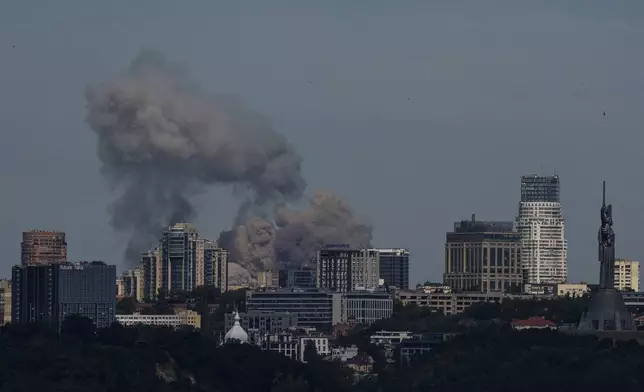 Smoke rises over the Kyiv skyline after a Russian attack, Monday, July 8, 2024. Russian forces launched multiple ballistic and cruise missiles against Ukrainian targets on Monday, Ukraine’s air force said, with explosions felt and heard across the capital, Kyiv. (AP Photo/ Evgeniy Maloletka)