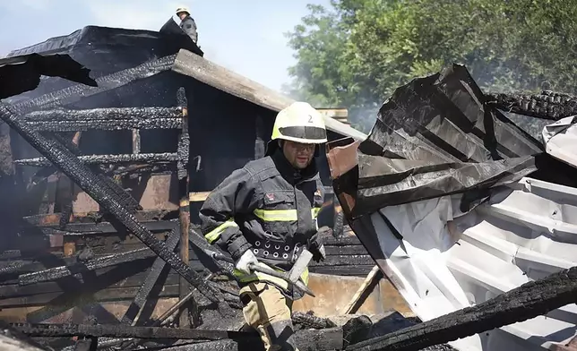 In this photo released by the Dnipro Regional Administration, rescuers work on the scene of a building damaged during Russia's missile attack in Dnipro, Ukraine, Wednesday, July 3, 2024. (Dnipro Regional Administration via AP)
