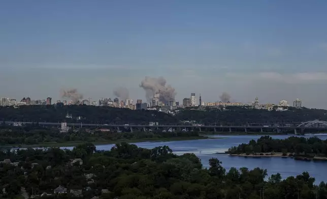 Smoke rises over the Kyiv skyline after a Russian attack, Monday, July 8, 2024. Russian forces launched multiple ballistic and cruise missiles against Ukrainian targets on Monday, Ukraine’s air force said, with explosions felt and heard across the capital, Kyiv. (AP Photo/ Evgeniy Maloletka)