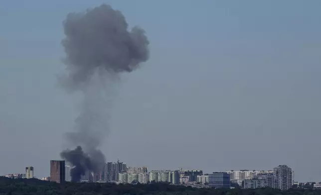 Smoke rises over the Kyiv skyline after a Russian attack, Monday, July 8, 2024. Russian forces launched multiple ballistic and cruise missiles against Ukrainian targets on Monday, Ukraine’s air force said, with explosions felt and heard across the capital, Kyiv. (AP Photo/ Evgeniy Maloletka)