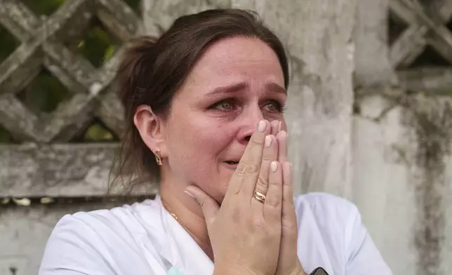 A woman reacts near the site of Okhmatdyt children’s hospital hit by Russian missiles, in Kyiv, Ukraine, Monday, July 8, 2024. Russian missiles have killed at least seven people and struck a children’s hospital in the Ukrainian capital, Kyiv, authorities say. (AP Photo/Evgeniy Maloletka)