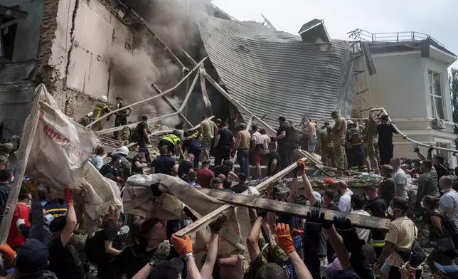 Rescue services at the site of Okhmatdyt children’s hospital hit by Russian missiles, in Kyiv, Ukraine. Monday, July 8, 2024. Russian missiles have killed at least seven people and struck a children’s hospital in the Ukrainian capital, Kyiv, authorities say. (AP Photo/Evgeniy Maloletka)