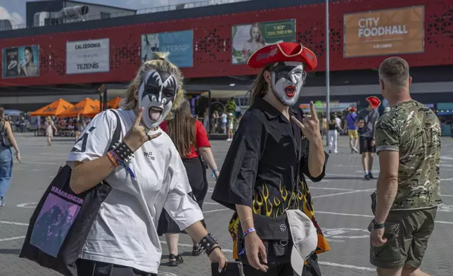 People with painted faces go to the Atlas Festival in Kyiv, Ukraine, Sunday, July 21, 2024. This year, Ukraine's largest music festival struck a different chord. Gone were the international headliners, the massive performance halls and the hundreds of thousands of visitors. (AP Photo/Anton Shtuka)