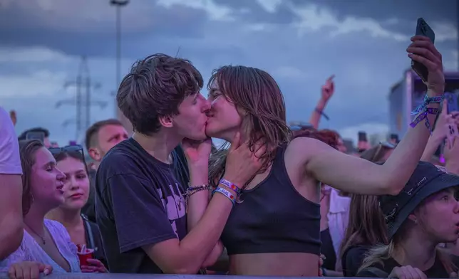 People enjoy a concert at the Atlas Festival in Kyiv, Ukraine, Sunday, July 21, 2024. This year, Ukraine's largest music festival struck a different chord. Gone were the international headliners, the massive performance halls and the hundreds of thousands of visitors. (AP Photo/Anton Shtuka)