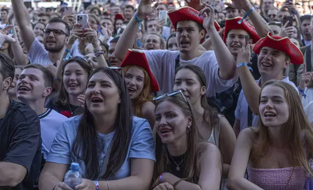 People enjoy a concert at the Atlas Festival in Kyiv, Ukraine, Sunday, July 21, 2024. This year, Ukraine's largest music festival struck a different chord. Gone were the international headliners, the massive performance halls and the hundreds of thousands of visitors. (AP Photo/Anton Shtuka)