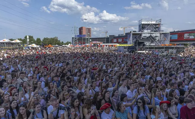 People enjoy a concert at the Atlas Festival in Kyiv, Ukraine, Sunday, July 21, 2024. This year, Ukraine's largest music festival struck a different chord. Gone were the international headliners, the massive performance halls and the hundreds of thousands of visitors. (AP Photo/Anton Shtuka)