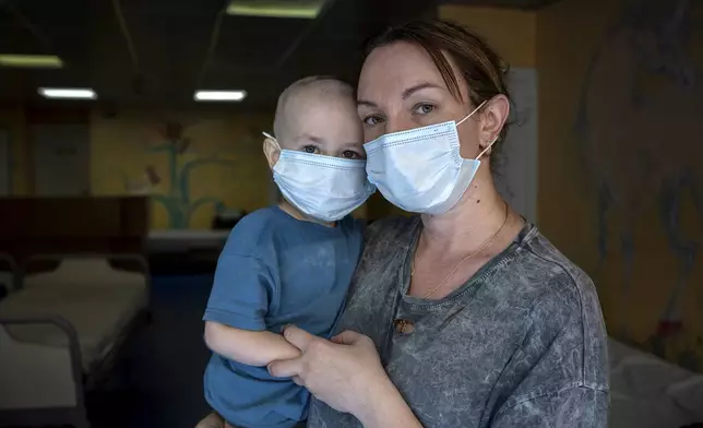 Oksana Halak poses for a portrait with her son Dmytro, 2, at the National Cancer Institute in Kyiv, Ukraine, Wednesday, July 10, 2024. Dmytro is one of 31 young patients battling cancer who were relocated to the hospital from Okhmatdyt Children’s Hospital after it was struck by a Russian missile this week. (AP Photo/Alex Babenko)