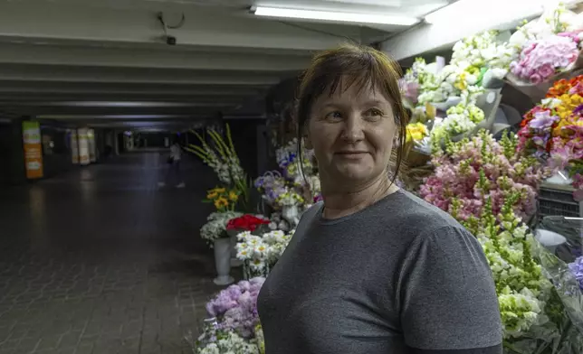 Olha Semynog stands by her flower stall in an underpass in Kyiv, Ukraine, Tuesday, June 25, 2024. Despite hardships brought by war flowers fill Kyiv and other Ukrainian cities. They burst out of planters that line the capital's backroads and grand boulevards and are fixed to lampposts. Semynog sells bunches of flowers for $2.50 all the way up to giant bouquets for $75. (AP Photo/Anton Shtuka)