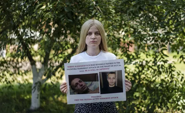 Mariia Alieksieievych, whose husband Serhii survived the explosions at the Russian-controlled Olenivka prison but is still a POW, attends a protest in Vinnitsia, Donetsk region, Ukraine, Saturday, July 13, 2024. Mariia last caught sight of him in his hospital bed in a video circulating on Russian media, slowly answering questions as he recovered from his injuries. (AP Photo/Evgeniy Maloletka)