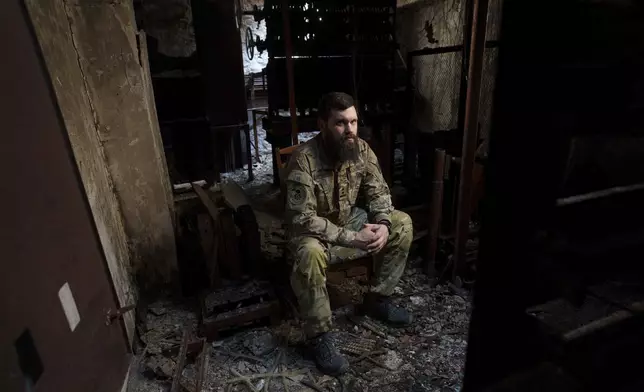 Lt. Col. Ihor Benzeruk, a Ukrainian soldier who survived the explosions at the Russian-controlled Olenivka prison two years ago, sits for a portrait in Lyman, Donetsk region, Ukraine, Thursday, July 11, 2024. "Thanks to the herd instinct, I managed to get out. For me, this day remains as the day my comrades were executed," Benzeruk said. (AP Photo/Evgeniy Maloletka)