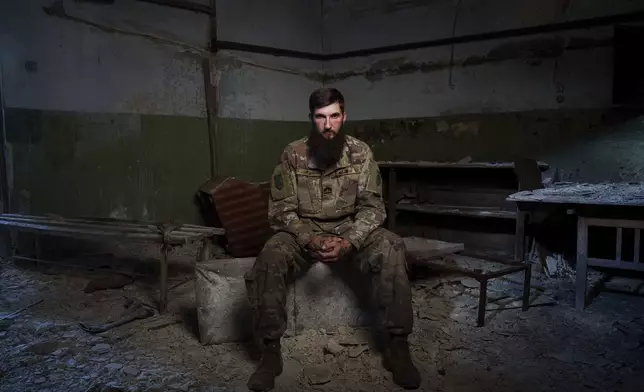 Sgt. Kyrylo Masalitin, known as Maslo, who survived the explosion at the Russian-controlled Olenivka prison two years ago that killed more than 50 Ukrainian POWs, sits for a portrait in Lyman, Donetsk region, Ukraine, Thursday, July 11, 2024. "In front of my eyes, there were guys who were dying, who were being revived, but it was all in vain," said Masalitin. (AP Photo/Evgeniy Maloletka)