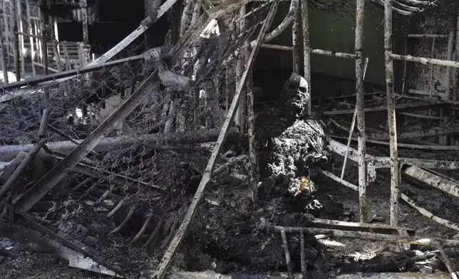 EDS NOTE: GRAPHIC CONTENT - FILE - The burned body of a Ukrainian POW lies in the destroyed barracks of the Russian-controlled prison in Olenivka, eastern Ukraine on Friday, July 29, 2022. More than 50 Ukrainians died and dozens were wounded. (AP Photo/File)