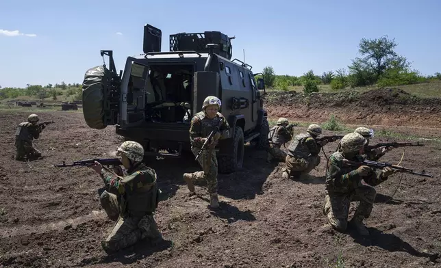 Convict prisoners which join Ukrainian army train at the polygon, in the Dnipropetrovsk region, Ukraine, Saturday, June 22, 2024. Ukraine is expanding its military recruiting to cope with battlefield shortages more than two years into fighting Russia’s full-scale invasion. (AP Photo/Evgeniy Maloletka)