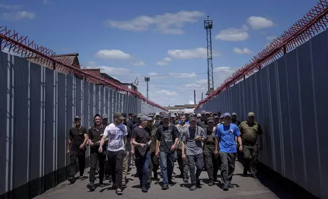 Prisoners go to lunch in a prison, in the Dnipropetrovsk region, Ukraine, Friday, June 21, 2024. Ukraine is expanding its military recruiting to cope with battlefield shortages more than two years into fighting Russia’s full-scale invasion. (AP Photo/Evgeniy Maloletka)