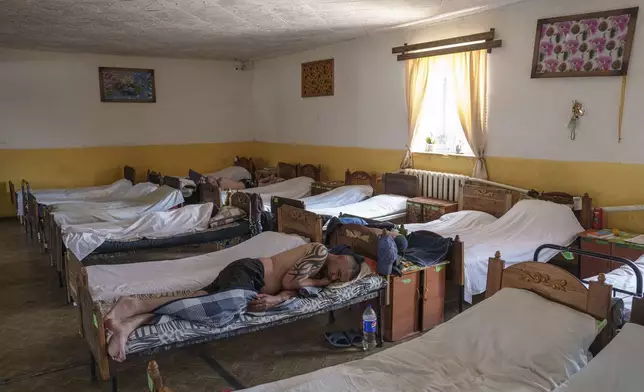 Prisoners sleep on beds in the barracks in a prison, in the Dnipropetrovsk region, Ukraine, Friday, June 21, 2024. Ukraine is expanding its military recruiting to cope with battlefield shortages more than two years into fighting Russia’s full-scale invasion. (AP Photo/Evgeniy Maloletka)