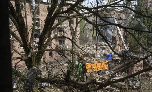 Rescuers clean up the rubble and search victims after Russian missile hit an apartment house in Kyiv, Ukraine, Monday, July 8, 2024. The daytime barrage targeted five Ukrainian cities with more than 40 missiles of different types hitting apartment buildings and public infrastructure, President Volodymyr Zelenskyy said on social media. (AP Photo/Evgeniy Maloletka)