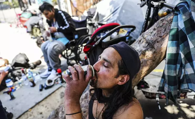 A homeless man named Angel drinks a soda to keep cool during a heat wave in San Francisco on Wednesday, July 3, 2024. (Gabrielle Lurie/San Francisco Chronicle via AP)