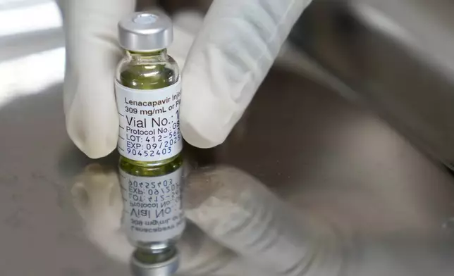 A pharmacist holds a vial of lenacapavir, the new HIV prevention injectable drug, at the Desmond Tutu Health Foundation's Masiphumelele Research Site, in Cape Town, South Africa, Tuesday, July 23, 2024, which was one of the sites for Gilead's lenacapavir drug trial. (AP Photo/Nardus Engelbrecht)