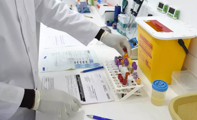 Lab technician, Xolile Mhlanga, works with vials of lenacapavir, the new HIV prevention injectable drug, at the Desmond Tutu Health Foundation's Masiphumelele Research Site, in Cape Town, South Africa, Tuesday, July 23, 2024. (AP Photo/Nardus Engelbrecht)